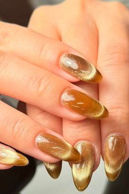 Honey Amber Cat Eye Nails - Warm honey amber with golden magnetic shimmer covers these medium length almond nails.