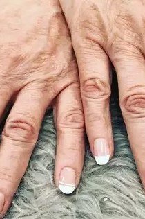 white french nails on aged hands
