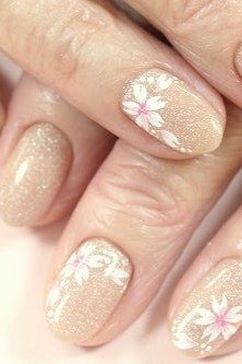 Nude with white-pink daisy art accents, mature hands - classy nail design for older women