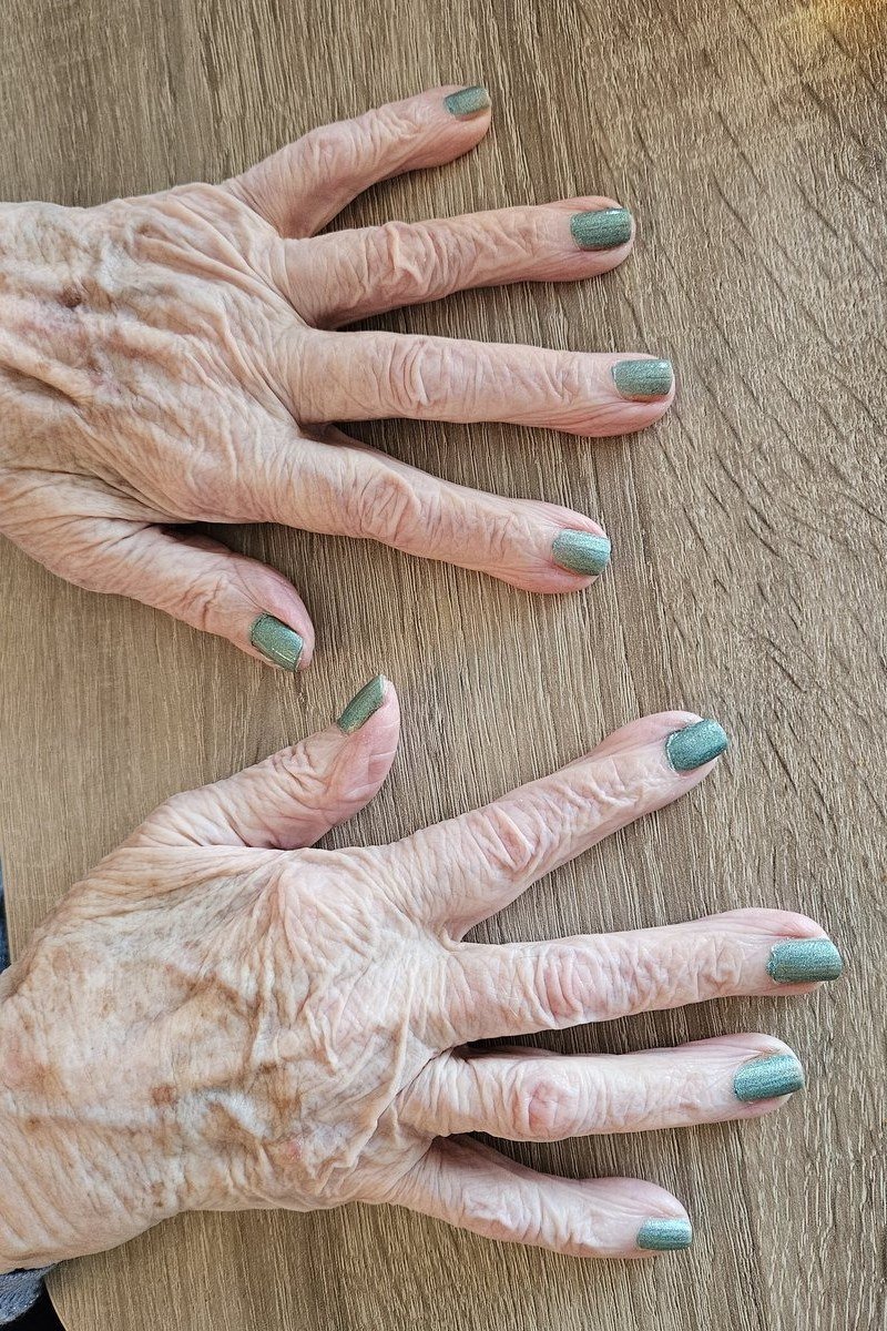 shimmery sage green nails for a soft twist for older women