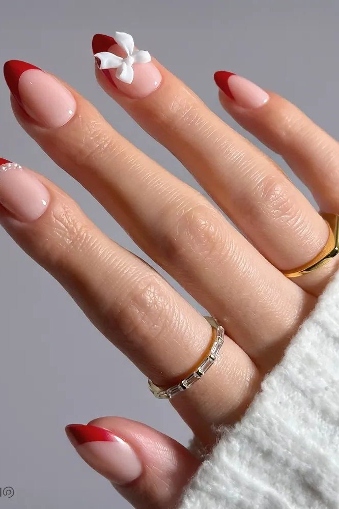 Red french tips with bow accent - Christmas nail design for older women