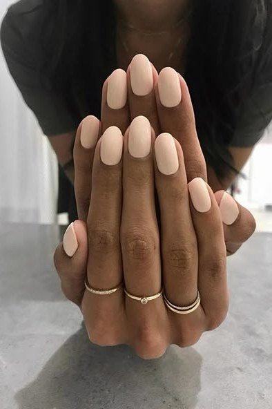 Almond nude nails with gold rings