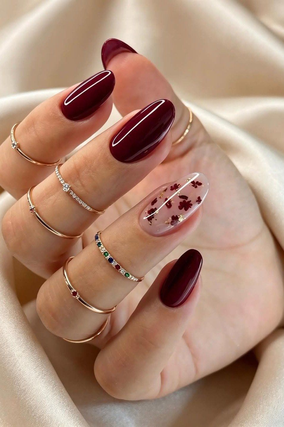 Deep burgundy nails with art accent nail, fall nail design for older women