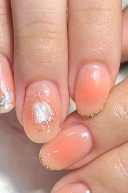 Peach ombre with small floral accent, medium nails, ombre nail design for women over 60