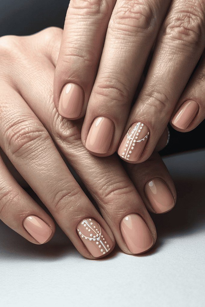 Nude nails with pearl dot accent nail art