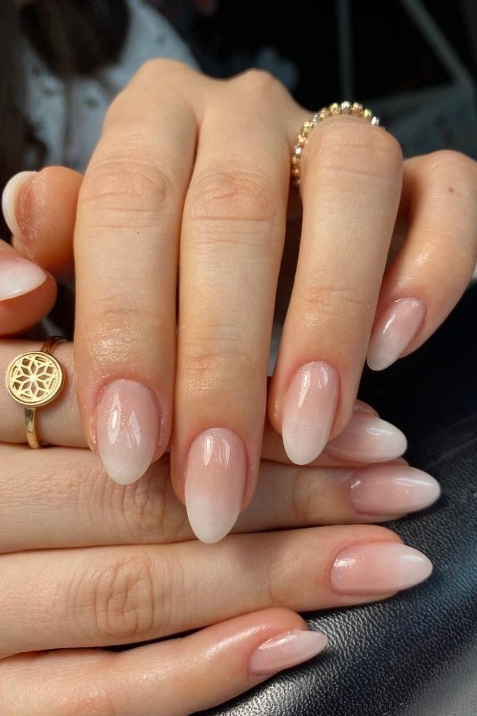 pink baby boomer fade on medium almond nails with gold rings