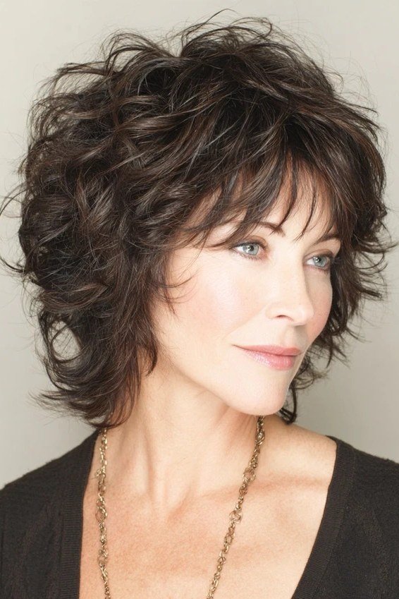 Chic Dark Curly Shag with Bangs - medium shag haircut for women over 40