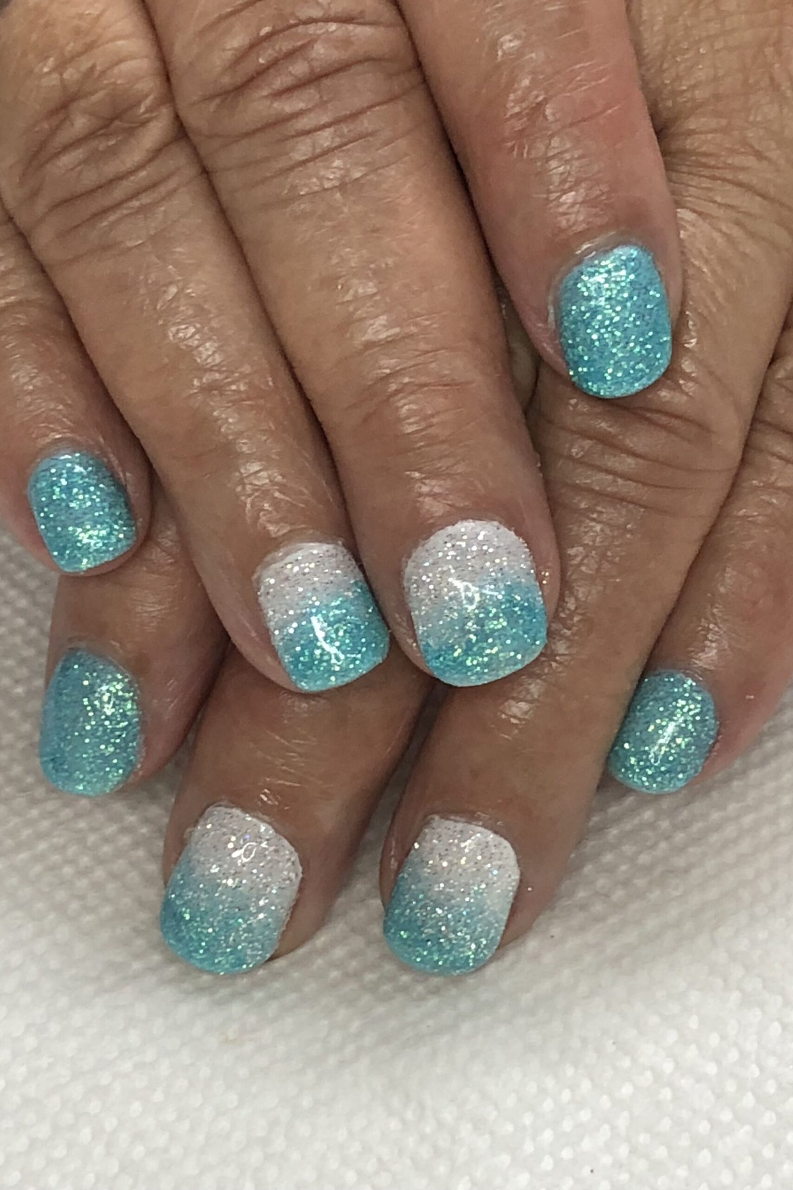 Turquoise Glitter Fade Gel Nails - short gel nail idea for women over 50