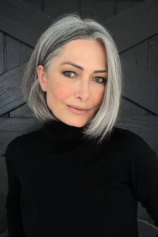 Sleek silver-grey french bob with sunglasses in side view