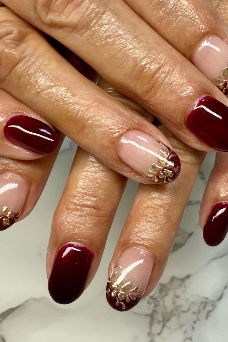 Burgundy nails with gold glitter french on mature hands, fall nail design for older women