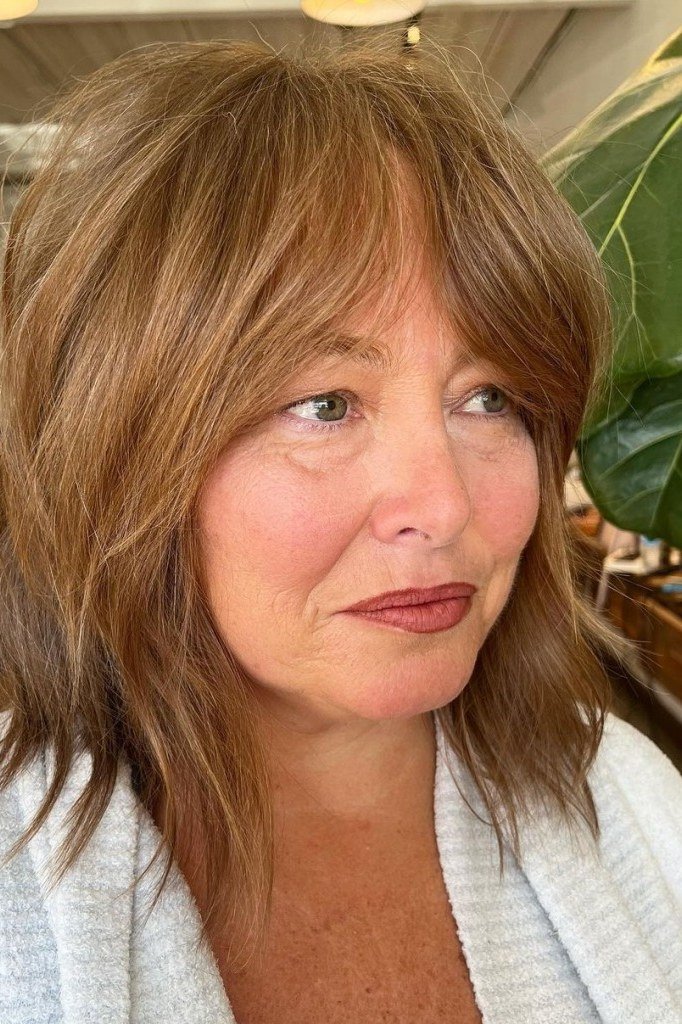 Modern Auburn Shag with Bangs - medium shag haircut for women over 40