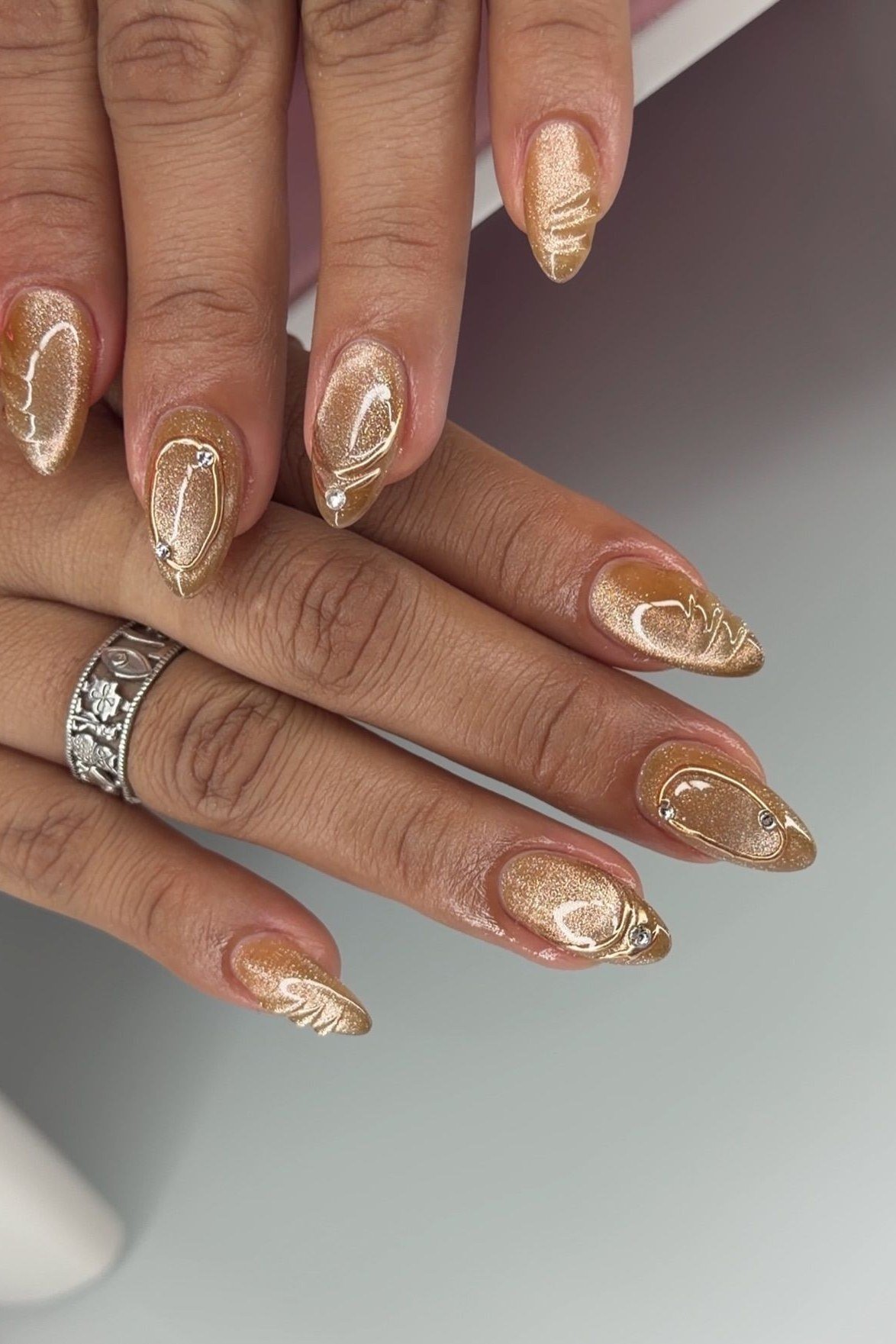 Champagne Pearl Cat Eye Nails - Soft champagne gold with pearl like magnetic shimmer and tiny pearl accents covers these medium length almond nails.