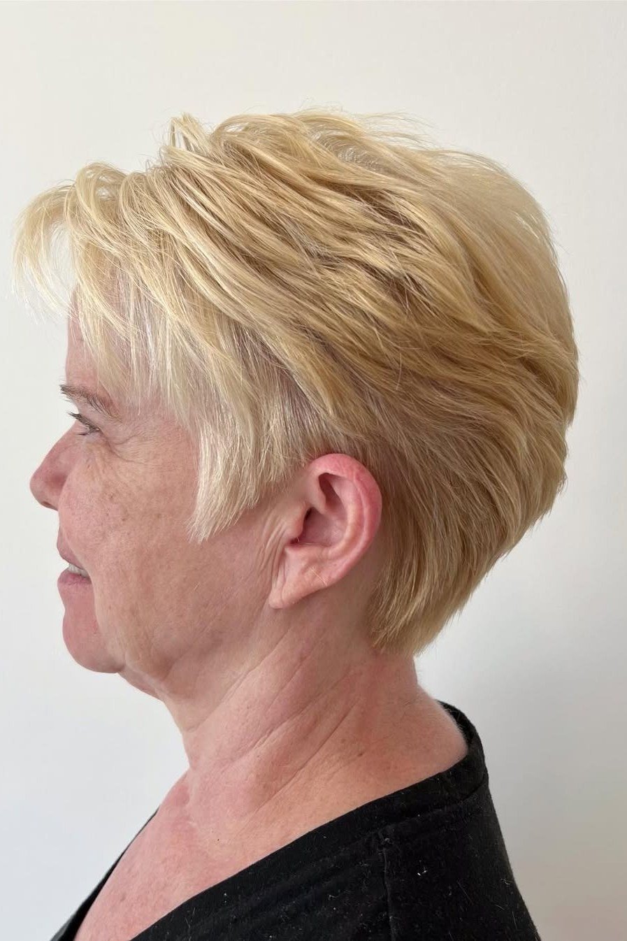Blonde tapered pixie haircut for women over 50