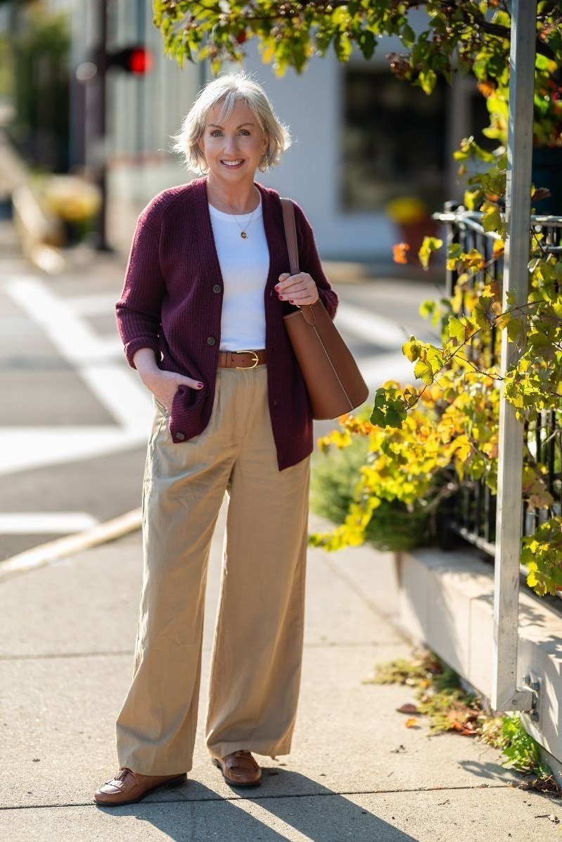 Burgundy cardigan with tan wide-leg pants fall outfit idea for women over 60