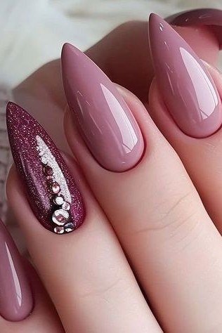 Glossy Mauve Stiletto Nails with a Rhinestone Accent, elegant mauve nail idea for women over 60