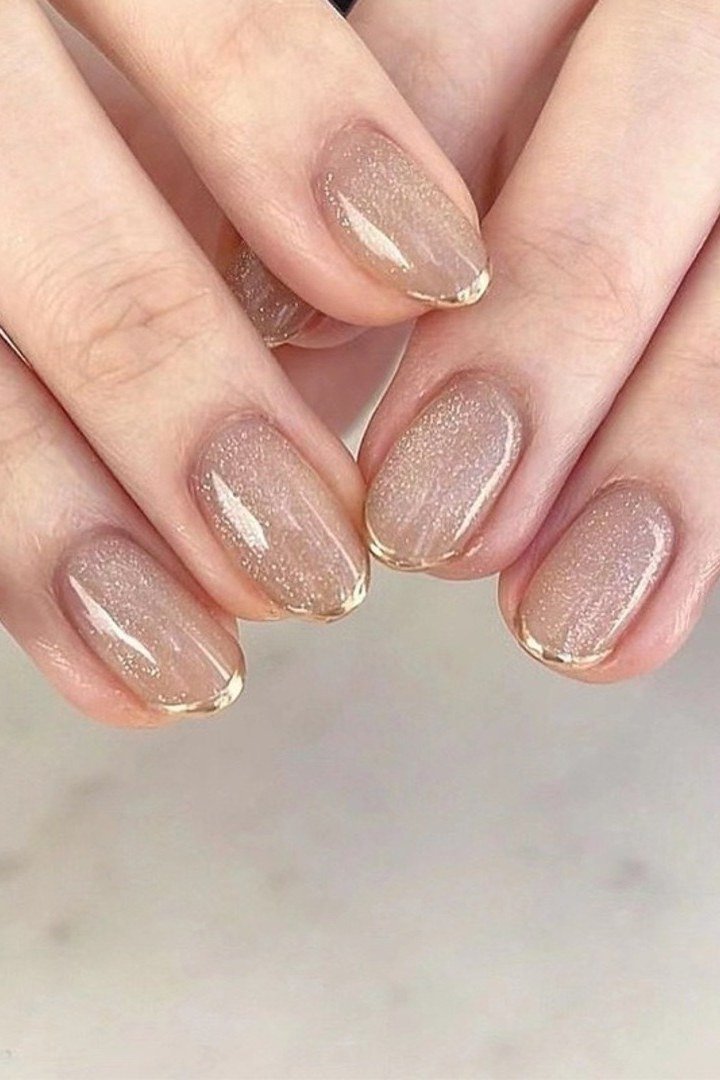 Sandy Shimmer Nude with Gold Cuticle - short nude nail idea for women over 50