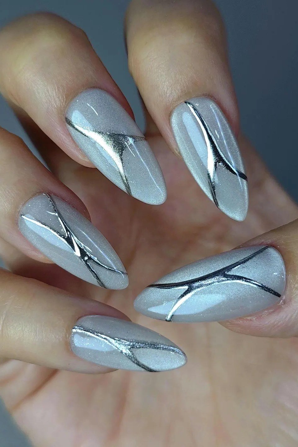 Icy Blue Cat Eye with Chrome Lines - Pale icy blue gray cat eye shimmer with silver chrome line art covers these medium length almond nails.