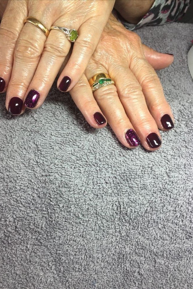dark plum on mature hands, grey fabric