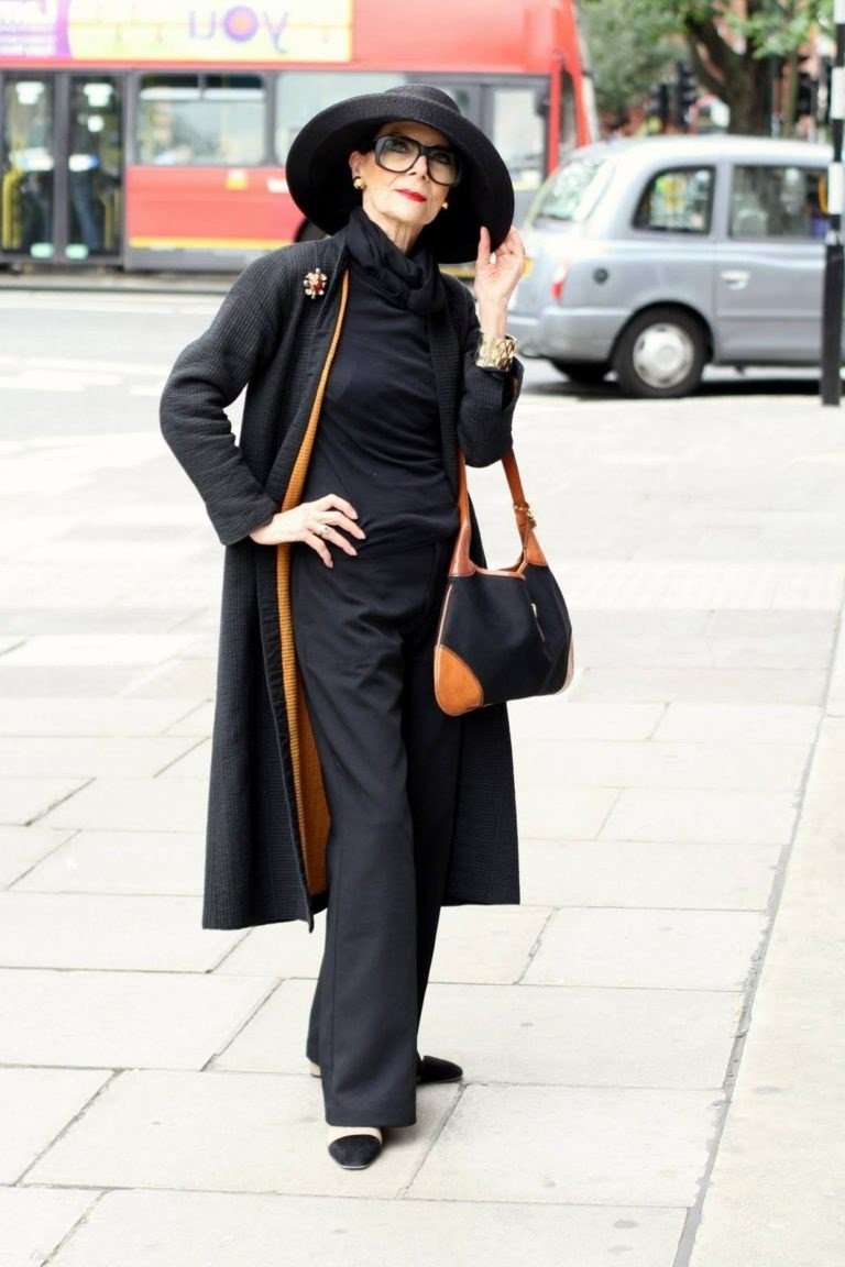 Effortlessly chic fall outfit for women over 60: black long coat with wide-brim hat