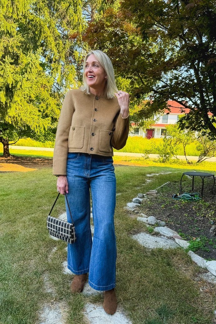 Tan knit sweater with blue jeans fall outfit idea for women over 60