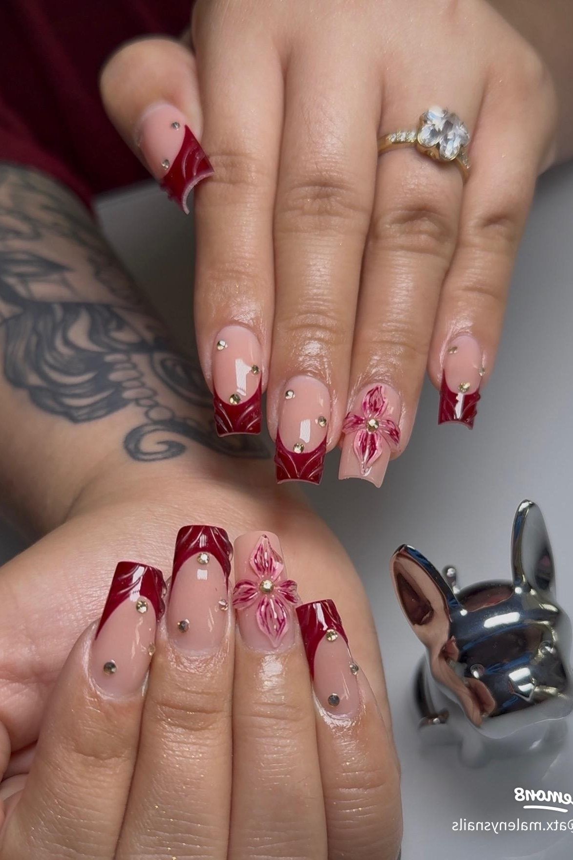 Red nails with pink floral art, fall nail design for older women