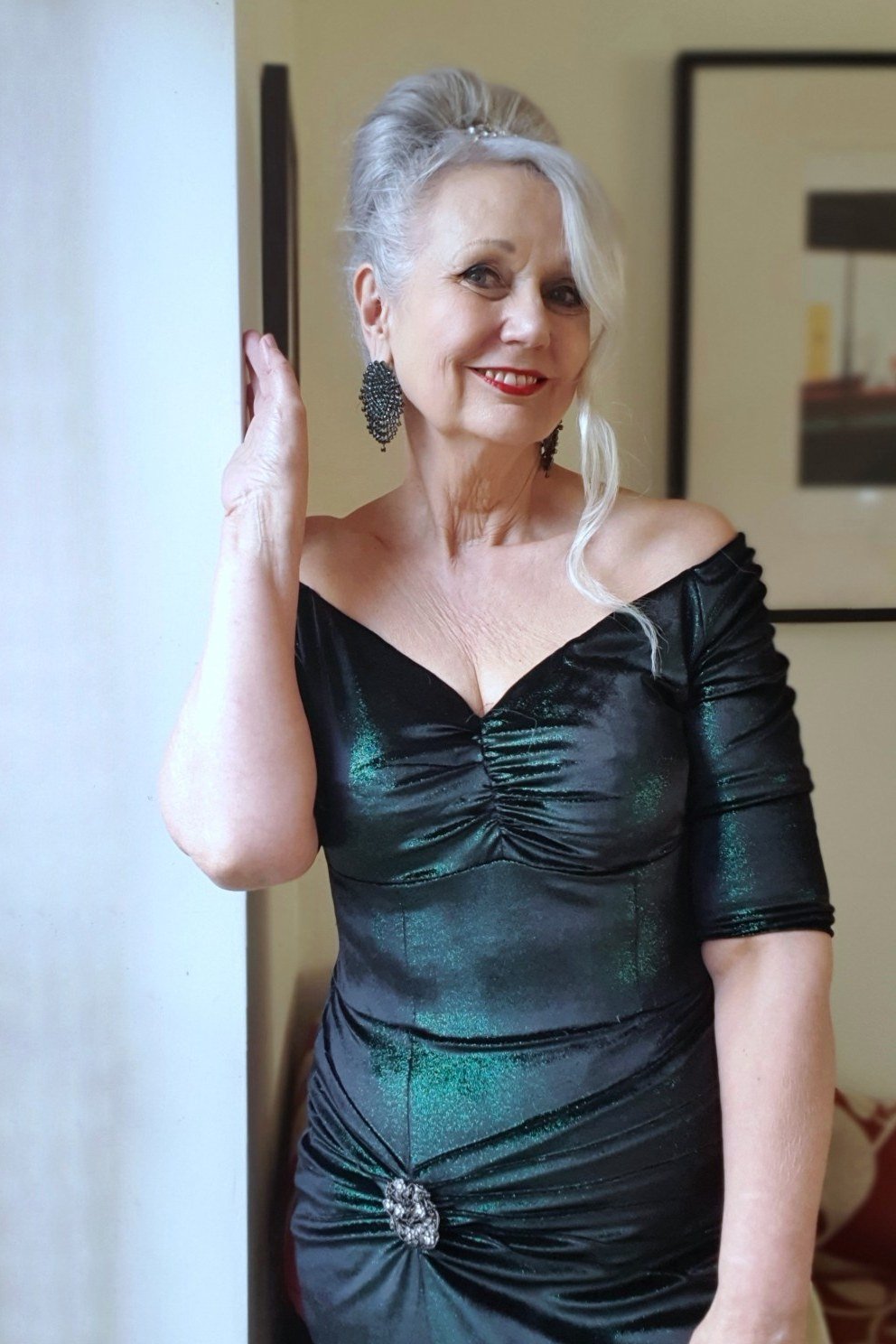 holiday evening outfit for women over 60: emerald off shoulder velvet dress