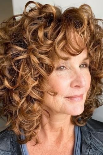 Copper curly medium with bangs front view - curly hairstyle for women over 60
