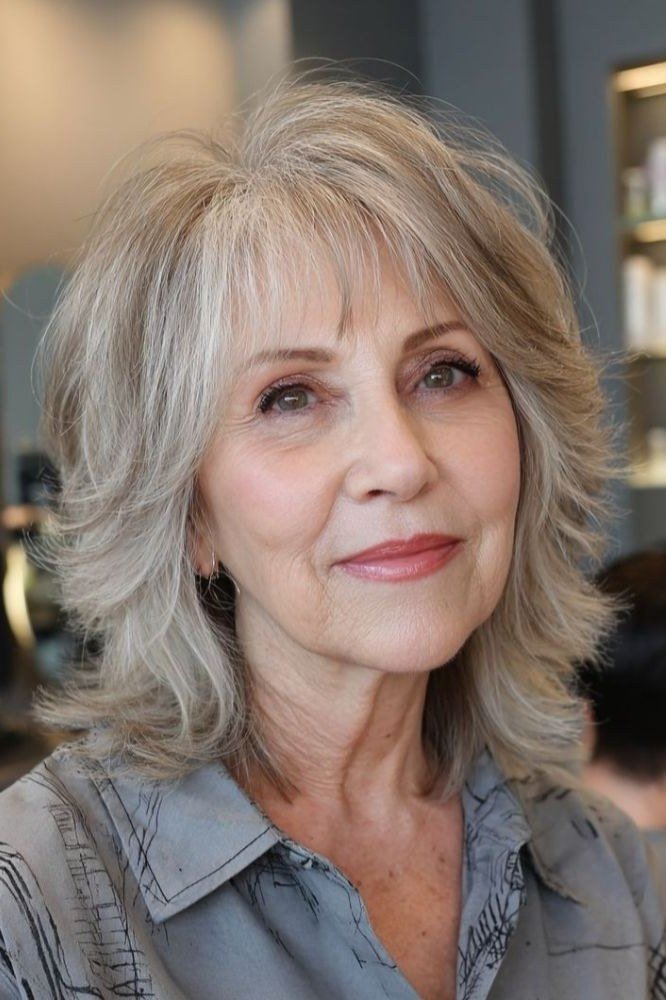 Silver shaggy medium cut with tousled texture for women over 60