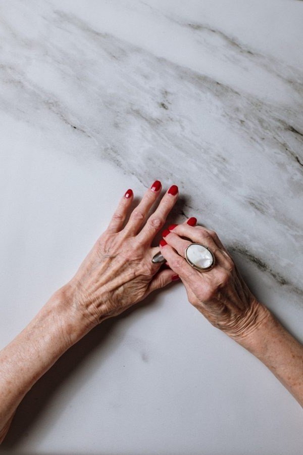 classic red on mature hands, marble