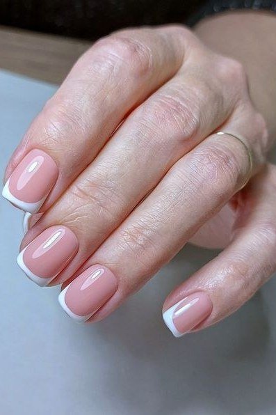 Short French manicure on older hands