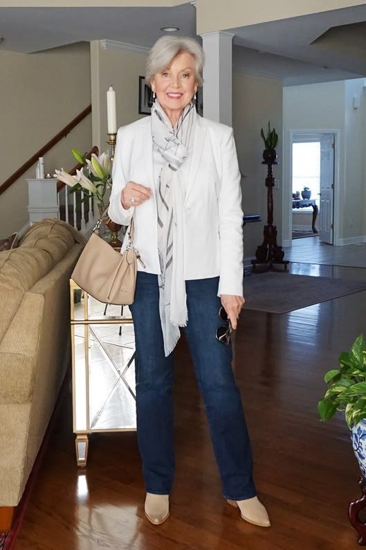 White blazer with white scarf and blue jeans for women over 50