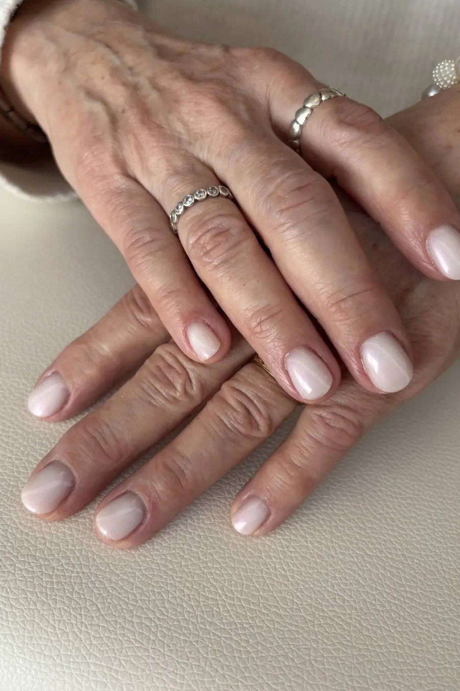 Older Hands Pale Nude Oval - elegant nude nail design for women over 60