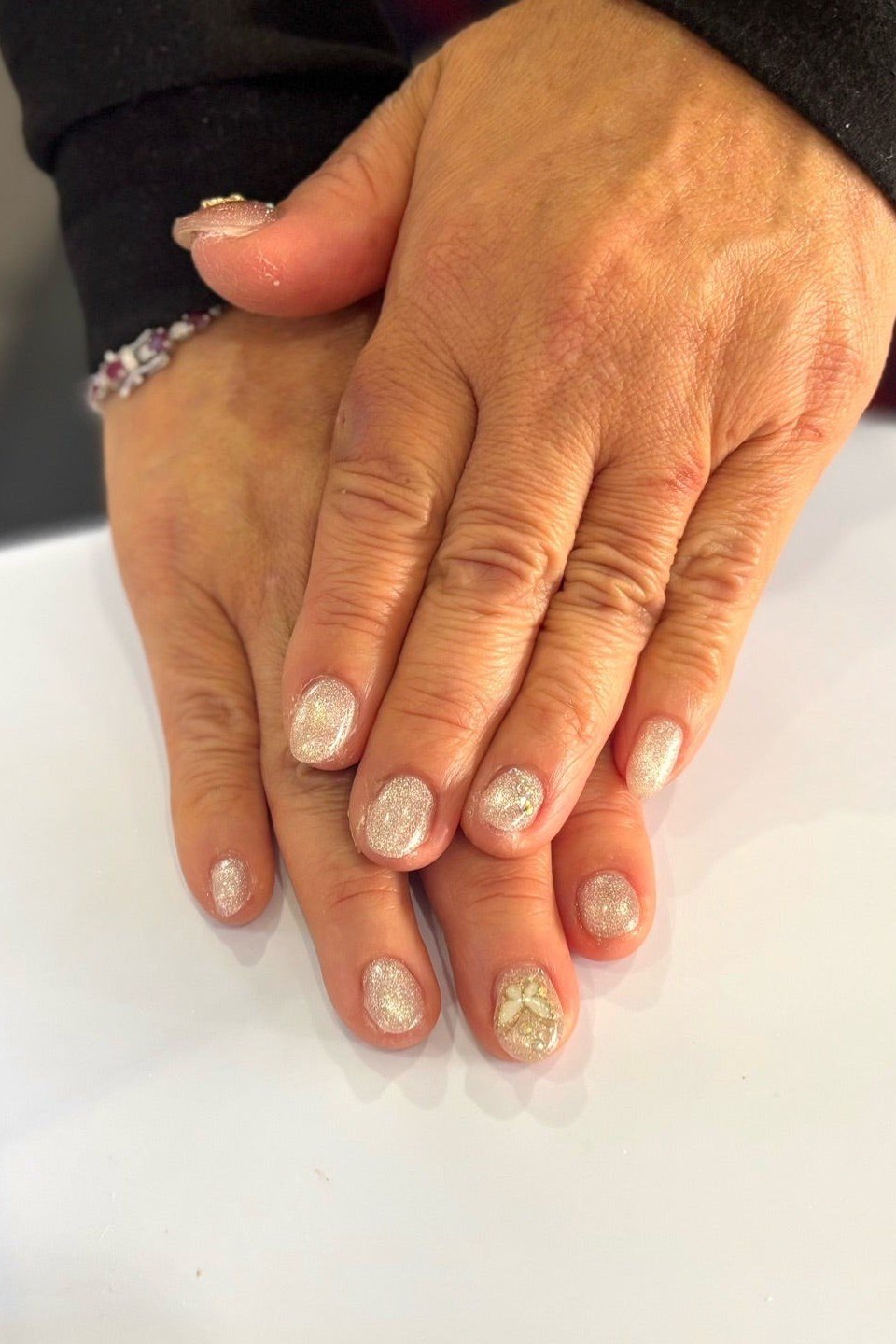 Nude with Gold Glitter Tips - short nude nail idea for women over 50