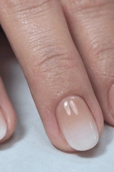 white pink baby boomer fade on short almond nails