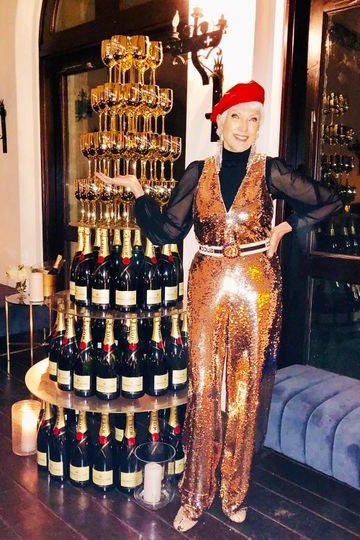 holiday evening outfit for women over 60: copper sequin jumpsuit with red beret