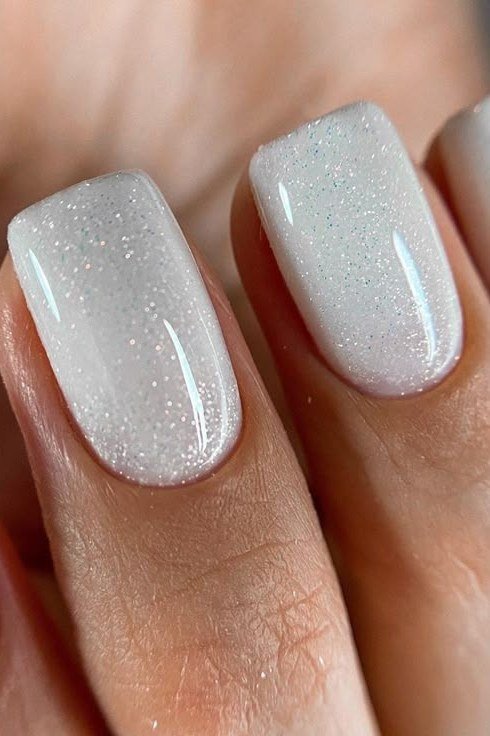 Glitter Cat-Eye on White - short nail design for women over 60 that makes nails look longer