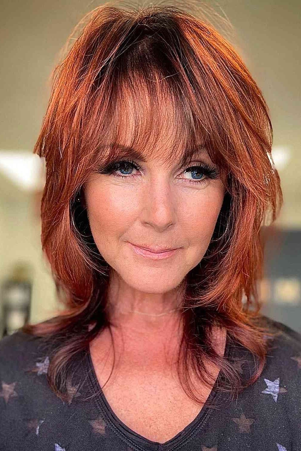copper red shaggy medium with bangs for women over 60