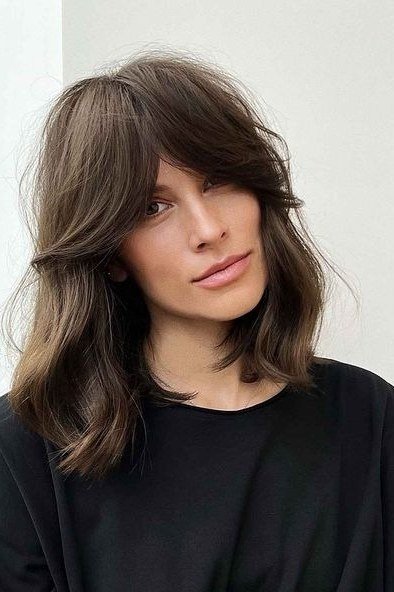 ash brown layered medium with side-swept bangs for women over 60