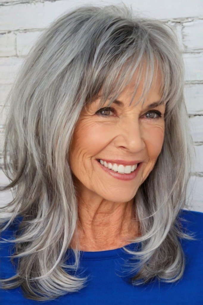 silver-gray layered medium with bangs for women over 60