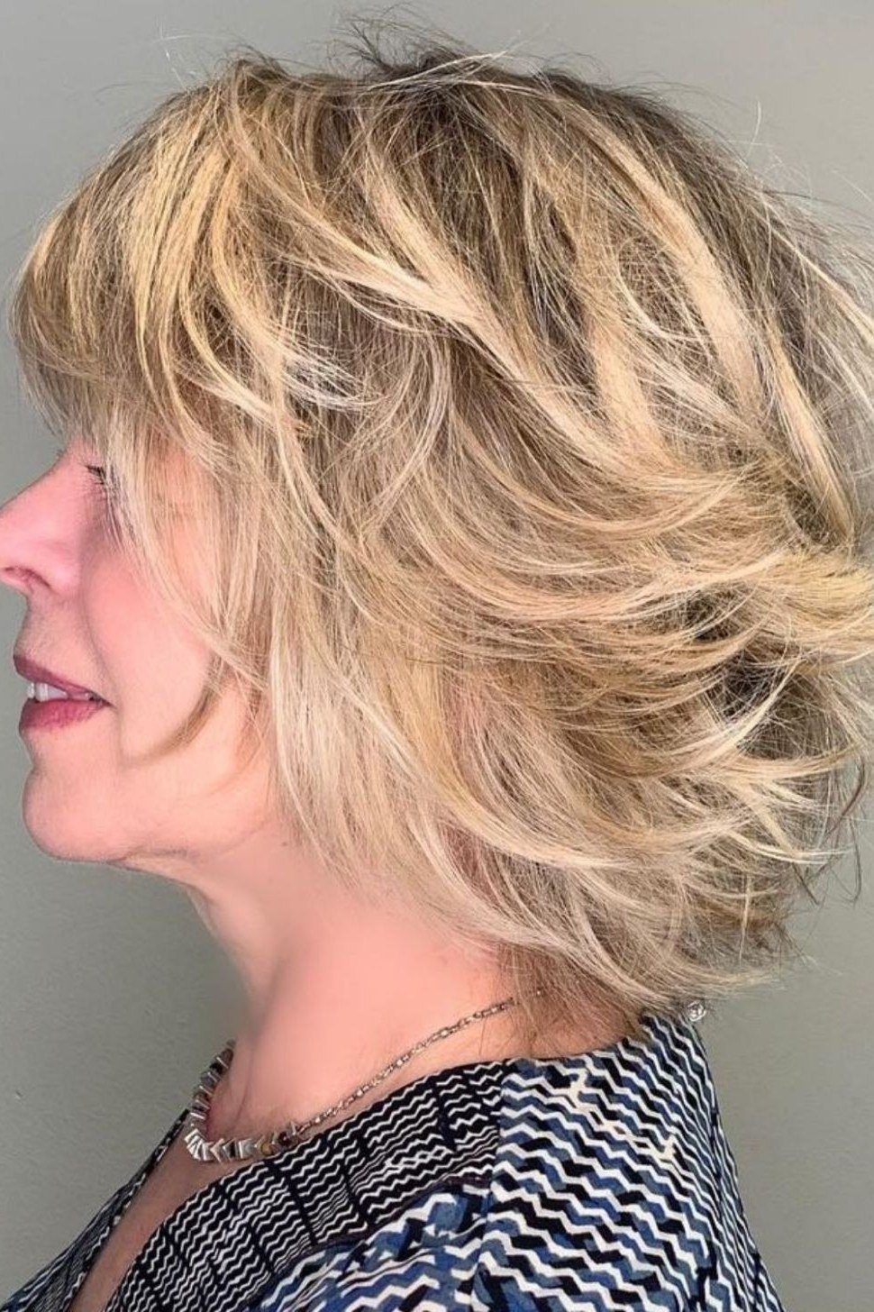 blonde shaggy layered bob, side view — chin-length layered bob hairstyle for women over 50