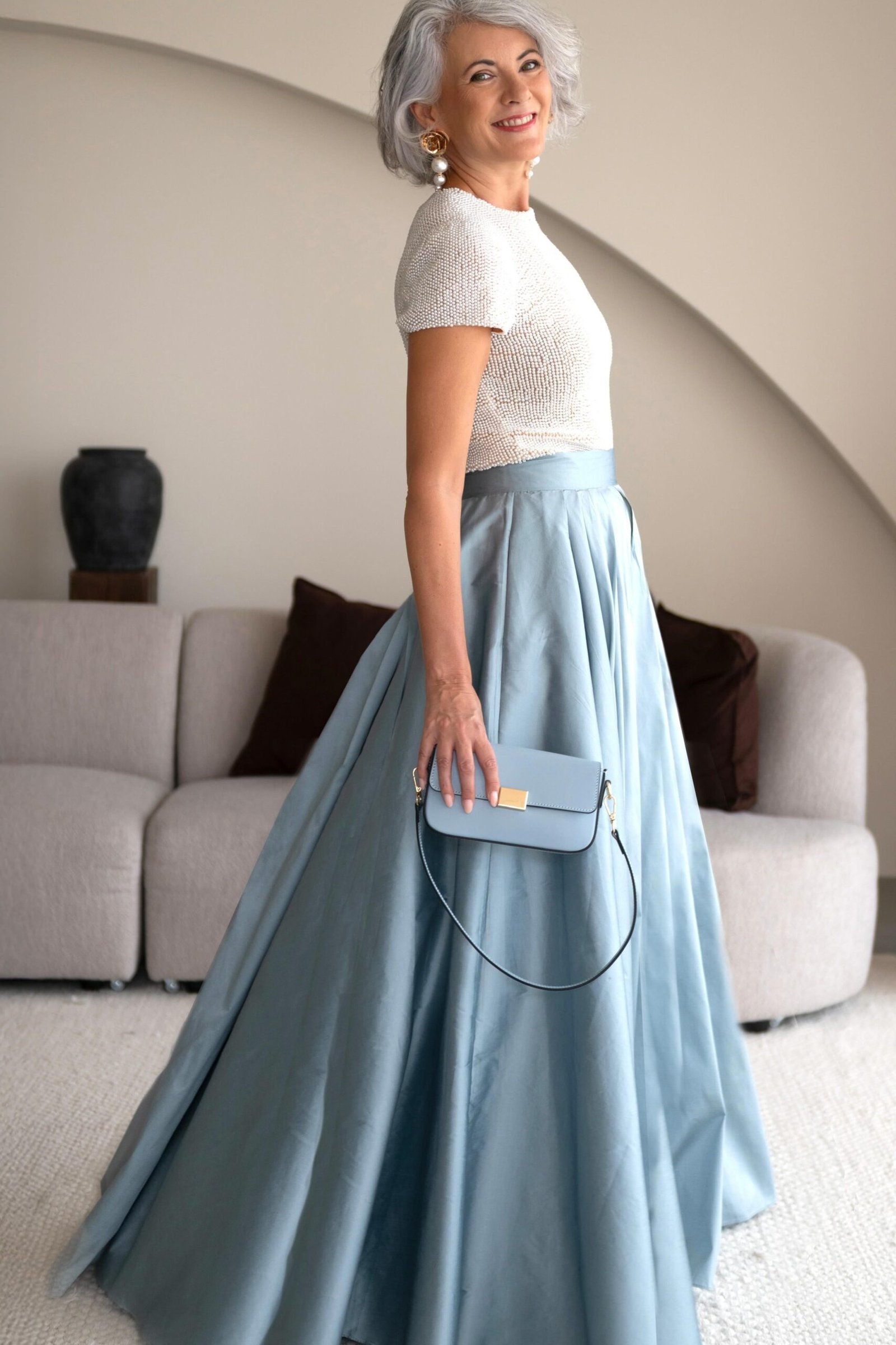 holiday evening outfit for women over 60: pale blue satin ballgown with white top