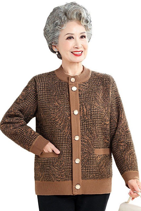 Older Asian woman smiling, wearing a brown tweed cardigan-style jacket