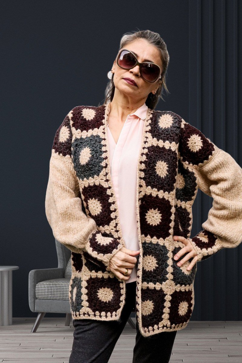 Woman with sunglasses wearing a brown and cream crochet granny-square cardigan