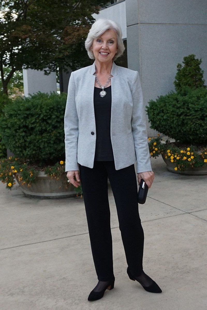 Light gray blazer with black top and black trousers, outdoor