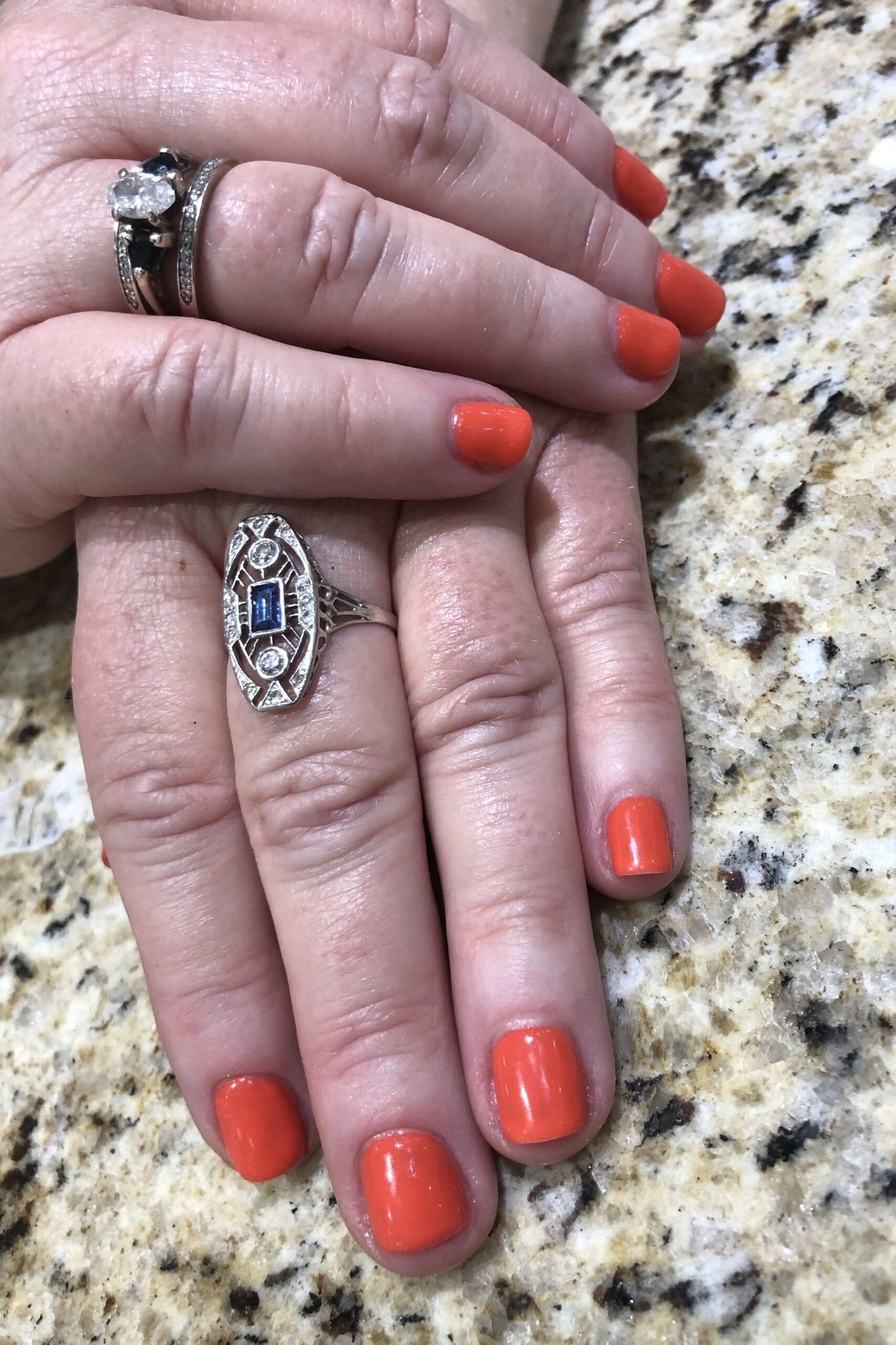 Bright Coral-Orange Round Nails with Gold Rings, best nail colors for 50 year olds