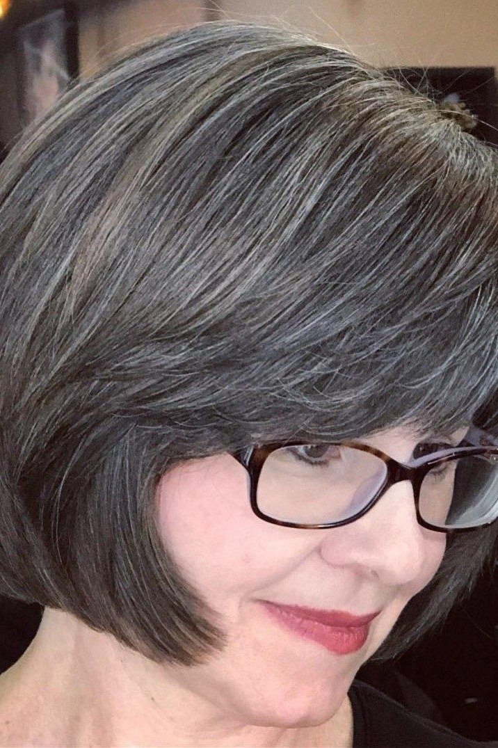 Dark gray rounded bob with black glasses for older women