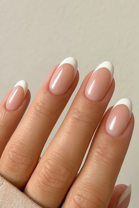 Medium oval French manicure on a nude base, elegant builder gel nails for women over 50