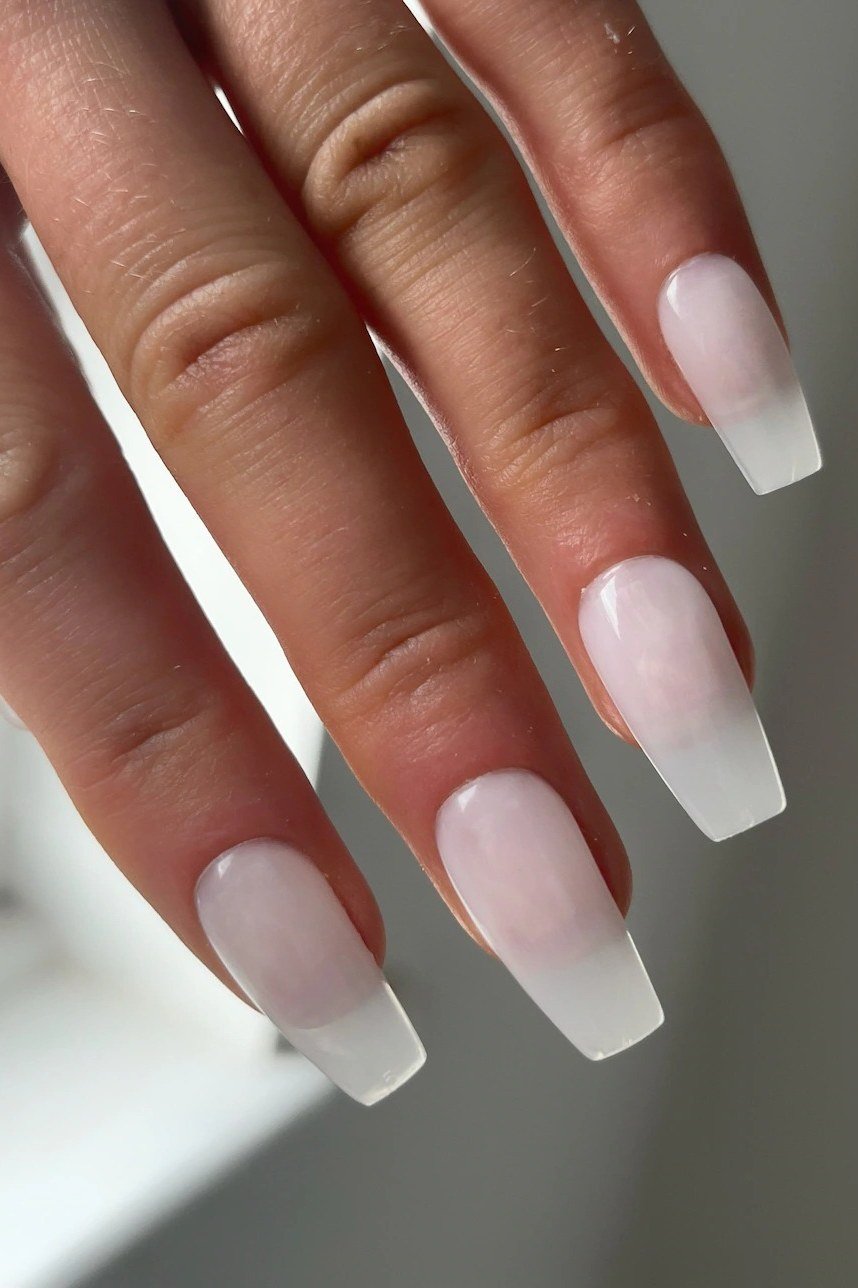 Milky white builder gel with soft French tip fade on medium almond nails