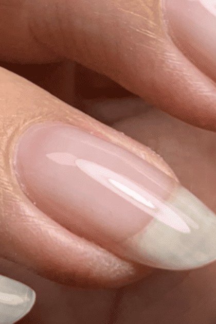 Natural French almond close-up with sheer pink base, builder gel manicure
