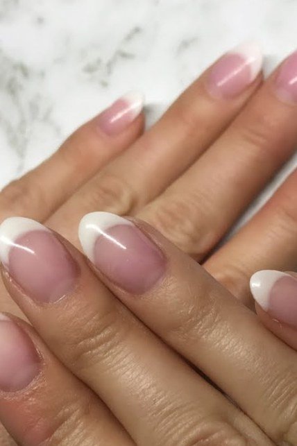 Oval French on two hands with soft pink base, builder gel nails over 50